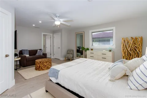 a bedroom with a bed and ceiling fan