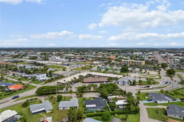an aerial view of residential houses with city view