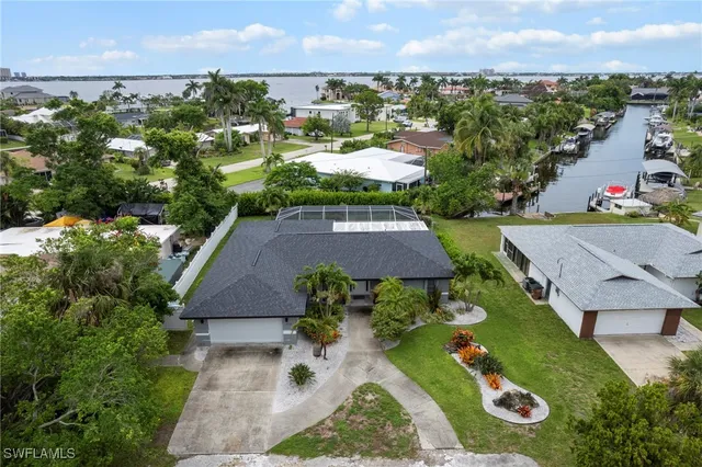 an aerial view of multiple houses with yard