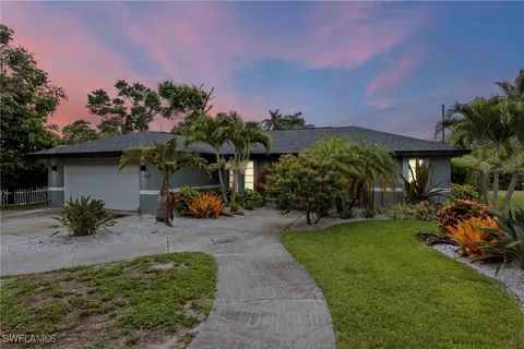 a front view of a house with garden and outdoor seating