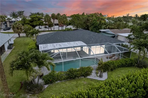a view of a house with a yard and sitting area