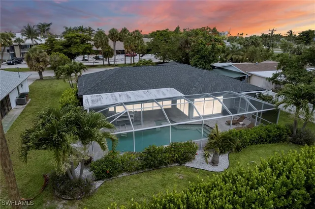 a view of a house with a yard and sitting area