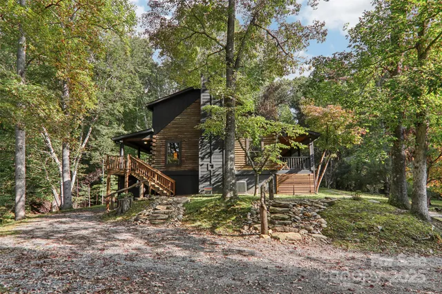 a view of a lush green field with lots of bushes