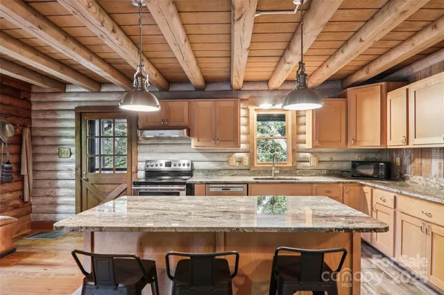 a bathroom with a double vanity sink a mirror and a shower