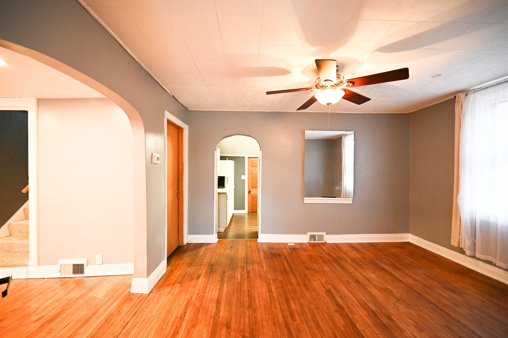 219 South 7th Street DeKalb, IL 60115 - Photo 10 of 30 a view of empty room with wooden floor and fan