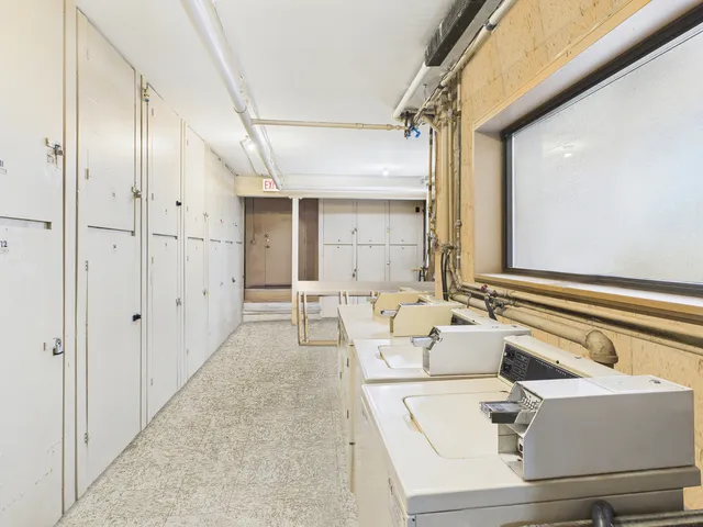 a living room with furniture and large windows