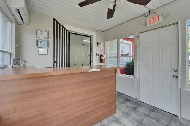 a living room with furniture a air conditioner vent and a window