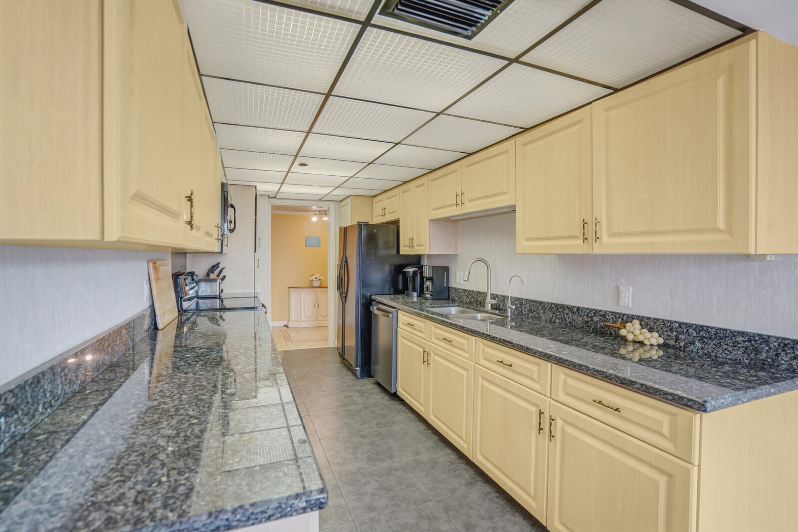 2667 North Ocean Boulevard, Unit I312 Boca Raton, FL 33431 - Photo 16 of 77 a kitchen with granite countertop a sink a stove and cabinets