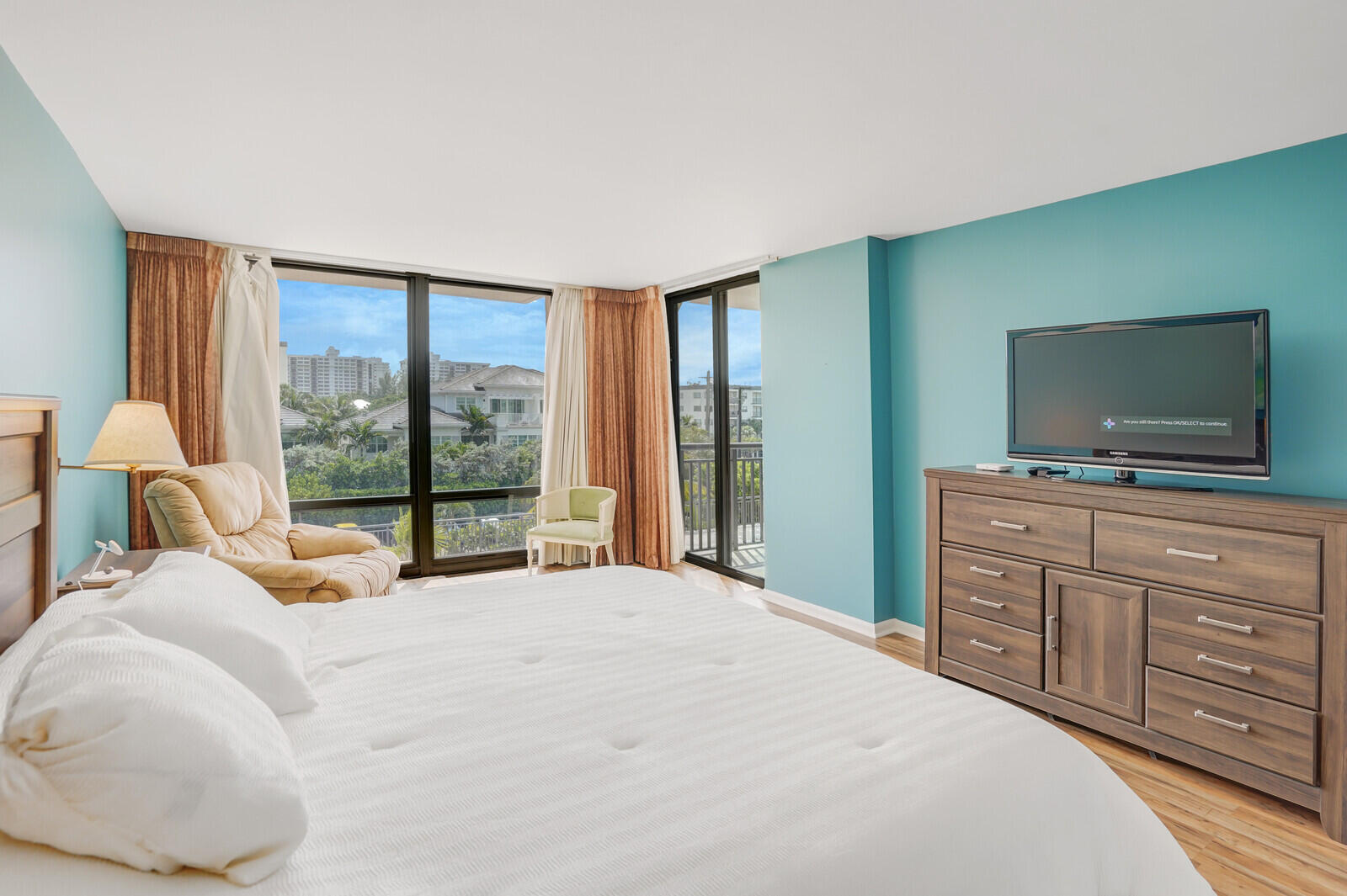 2667 North Ocean Boulevard, Unit I312 Boca Raton, FL 33431 - Photo 22 of 77 a bedroom with a large bed and a flat tv screen on dresser