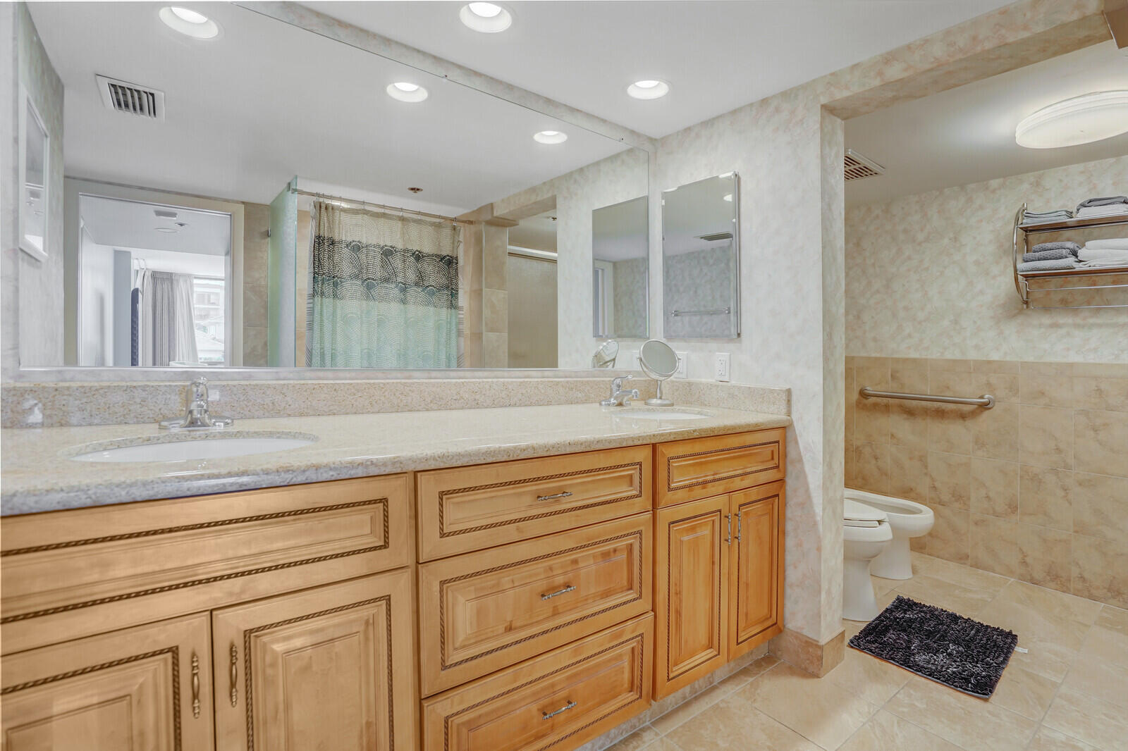 2667 North Ocean Boulevard, Unit I312 Boca Raton, FL 33431 - Photo 24 of 77 a bathroom with a sink a toilet and a mirror