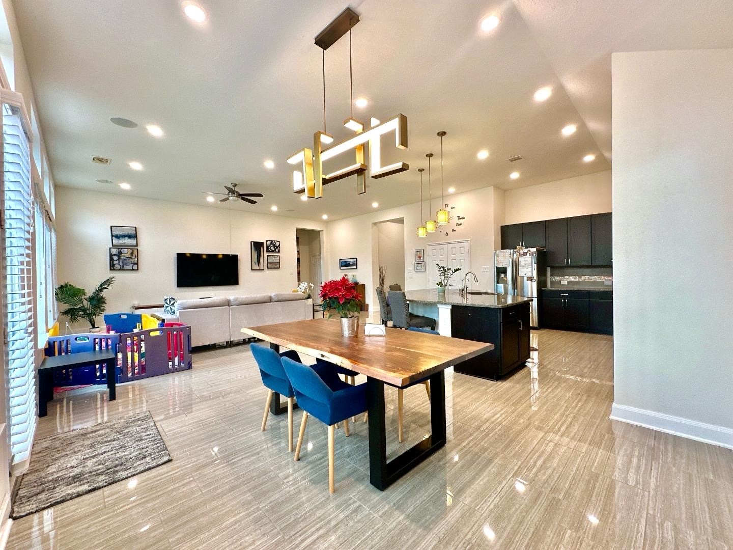 1110 Penny Ranch Lane Katy, TX 77494 - Photo 17 of 31 a kitchen with stainless steel appliances kitchen island granite countertop a refrigerator a stove top oven a dining table and chairs with wooden floor