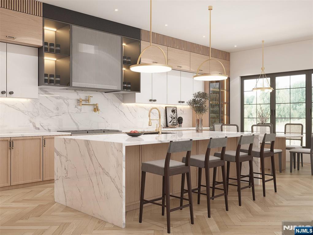 379 Anderson Avenue Alpine, NJ 07620 - Photo 3 of 15 a kitchen with a table chairs sink and cabinets
