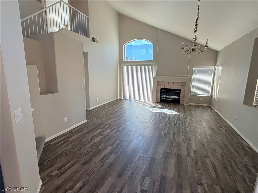 Vaulted ceilings and handsome plank flooring define this welcoming living area centered on a fireplace.