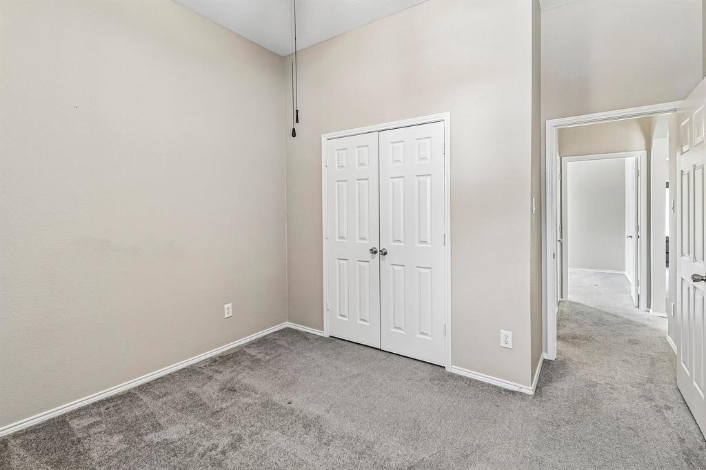 101 Ravinia Court Oak Point, TX 75068 - Photo 19 of 23 Vaulted ceiling with a ceiling fan, light gray wall finish, gray carpet flooring, and white paneled doors