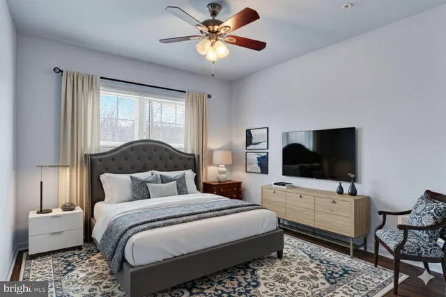 a bedroom with a bed and a flat screen tv