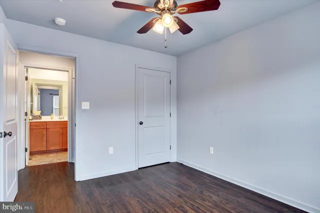 a view of an empty room and window and wooden floor