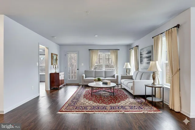 a living room with furniture rug and window