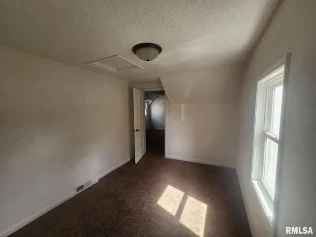 an empty room with a empty space and windows