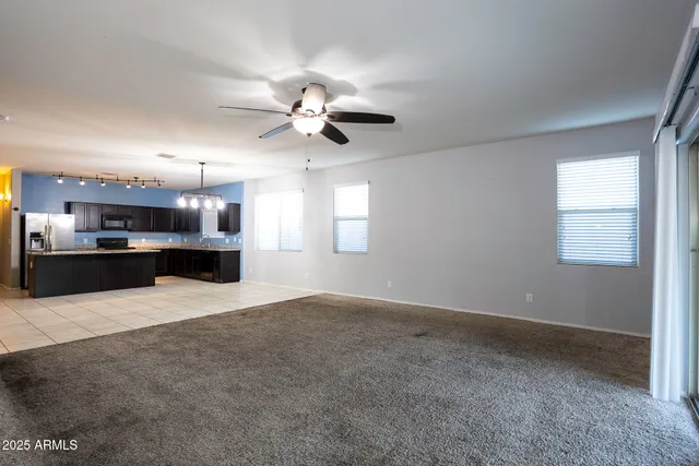 a view of a kitchen with a sink and a chandelier fan