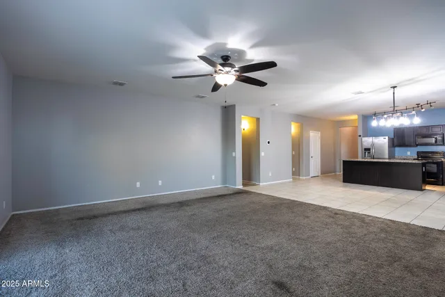 a kitchen with stainless steel appliances granite countertop a sink a stove and refrigerator