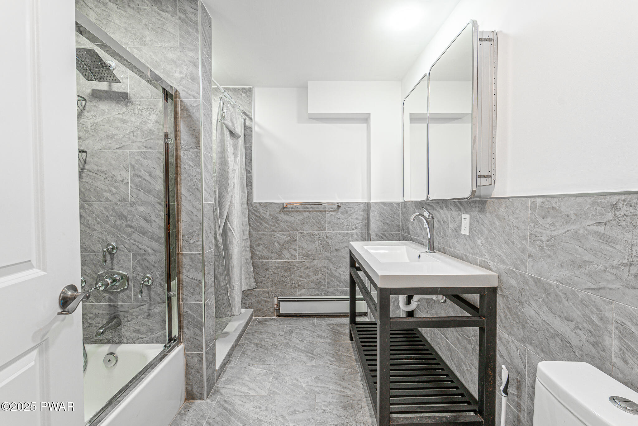 153 Hatton Road Hawley, PA 18428 - Photo 25 of 38 a bathroom with a sink a mirror and a bathtub