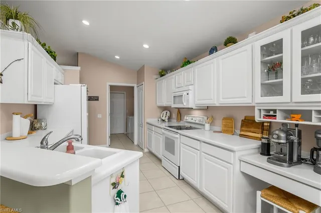 a kitchen with stainless steel appliances granite countertop a sink dishwasher stove and refrigerator
