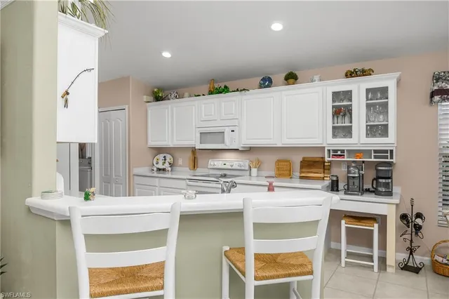 a kitchen with a sink cabinets and window
