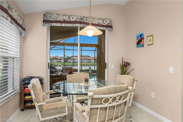 a kitchen with a sink a refrigerator and cabinets