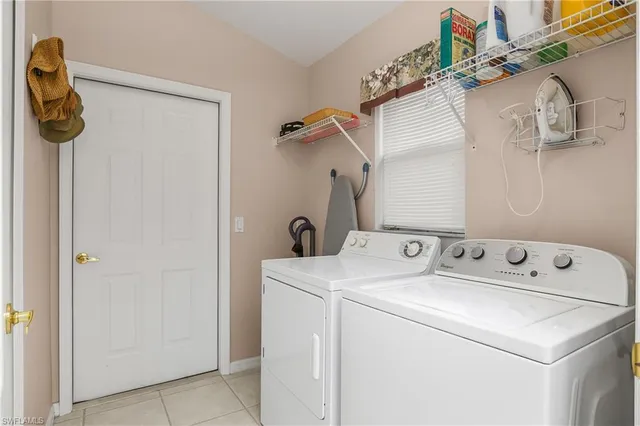 a bedroom with two beds and a chandelier