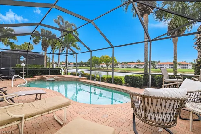 a dining room with furniture and a large window