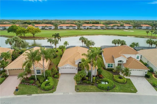 an aerial view of a house with a garden and lake view