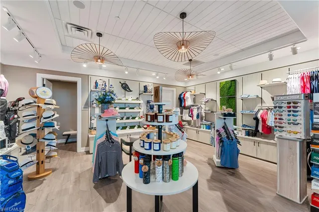 a dining room with furniture a chandelier and a large window