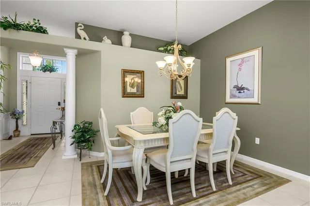 a view of a dining room with furniture and chandelier