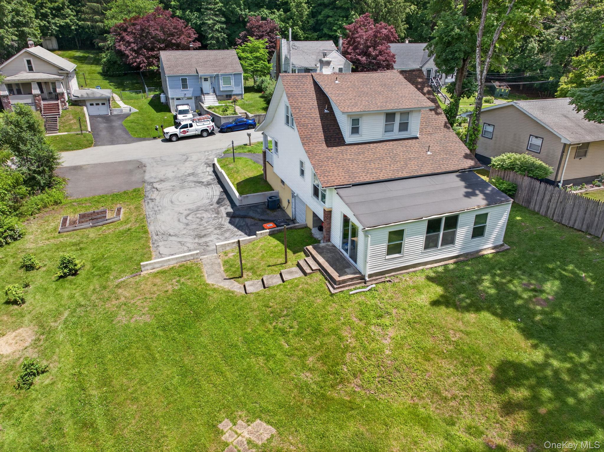 7 Walnut Street Poughkeepsie, NY 12601 - Photo 26 of 30 . The generous yard offers plenty of room for gardening, recreation, or future outdoor enhancements, while the home's timeless Cape Cod character creates a warm and welcoming backdrop for everyday living.