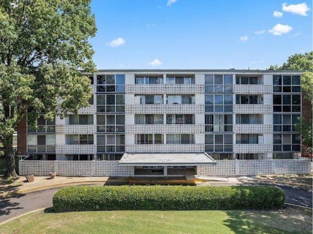 a front view of a building with a swimming pool