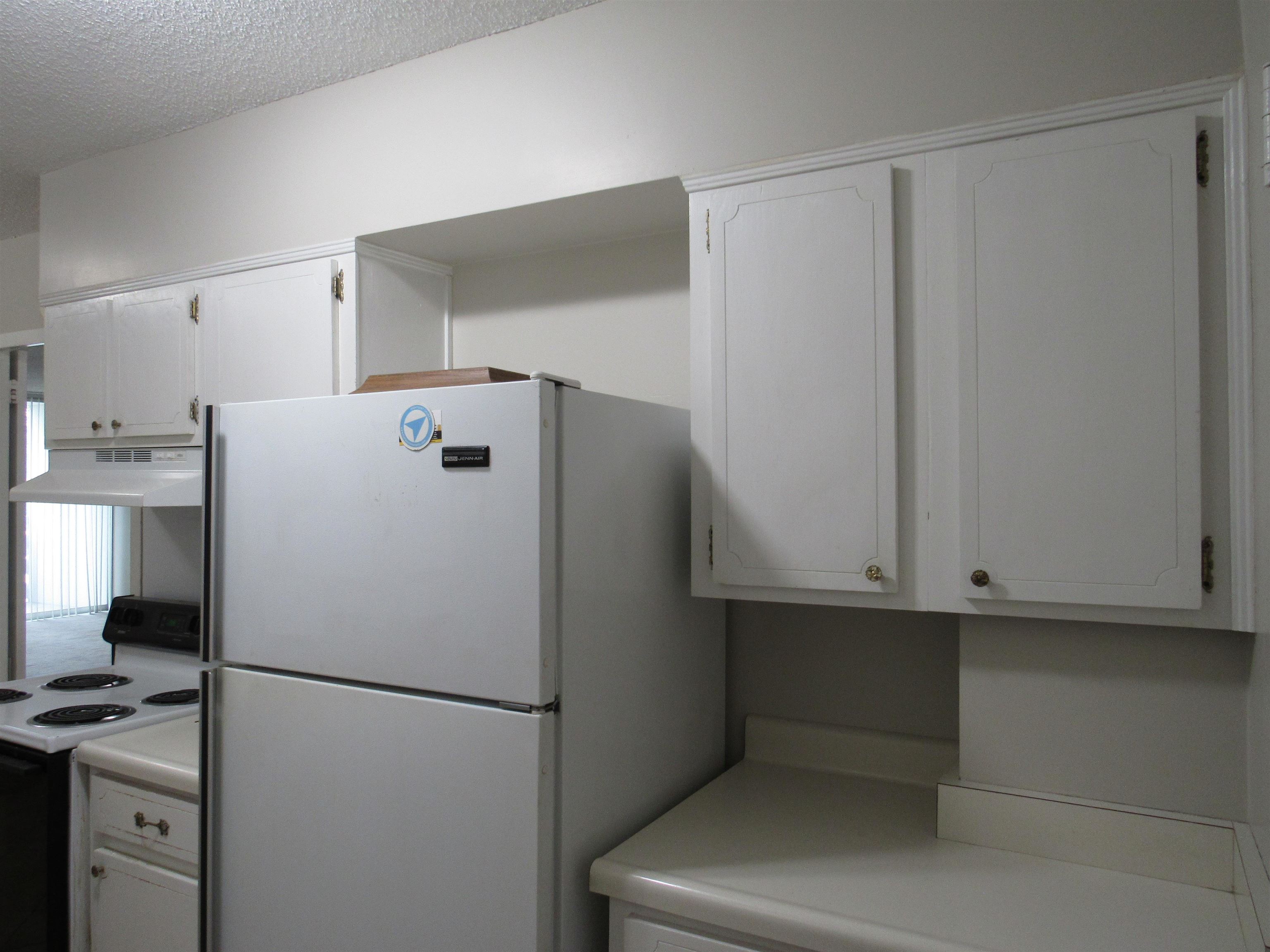 3080 Walnut Grove Road, Unit 205 Memphis, TN 38111 - Photo 7 of 26 a white refrigerator freezer sitting in a kitchen