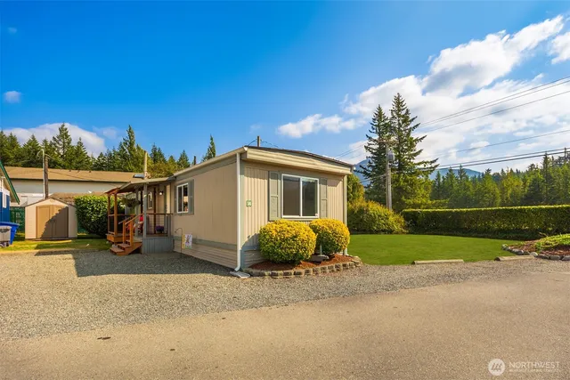 a blue house with trees in front of it