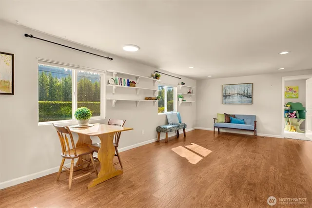 a workspace with furniture window and wooden floor