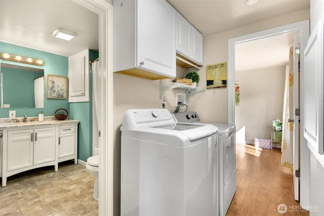 a utility room with cabinets washer and dryer