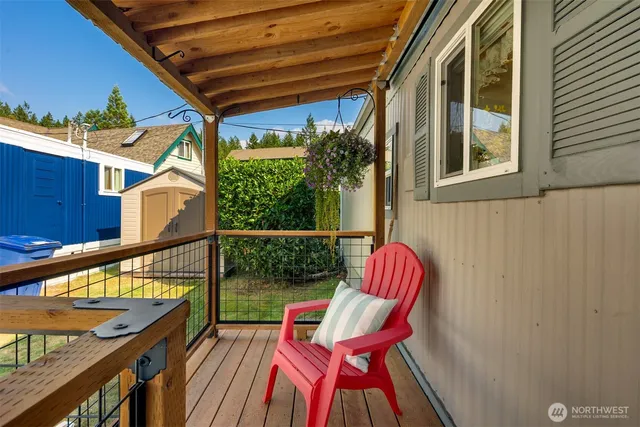 a balcony with wooden floor and furniture