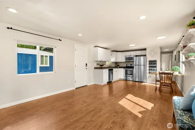 a living room with stainless steel appliances kitchen island granite countertop furniture and a kitchen view