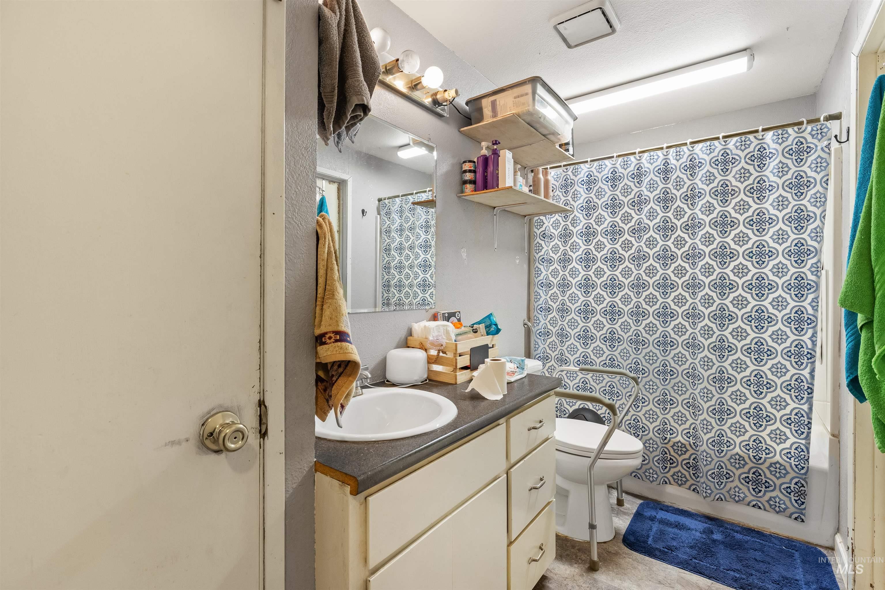 2460 State Street Pomeroy, WA 99347 - Photo 12 of 18 Bathroom featuring a white vanity with integrated sink, dark countertop, and decorative hardware