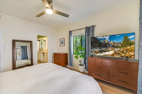 a bedroom with a bed and a flat screen tv
