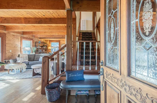 a view of entryway livingroom and hall with wooden floor