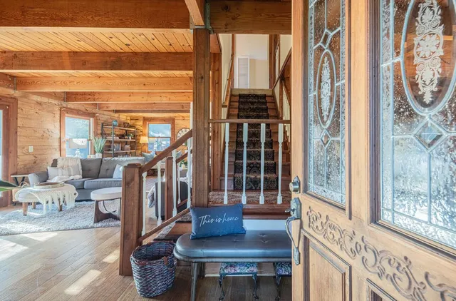 a view of entryway livingroom and hall with wooden floor
