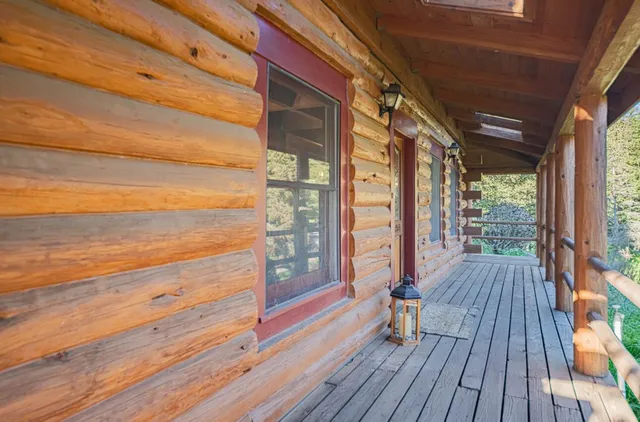 a view of a porch with wooden floor and outdoor space