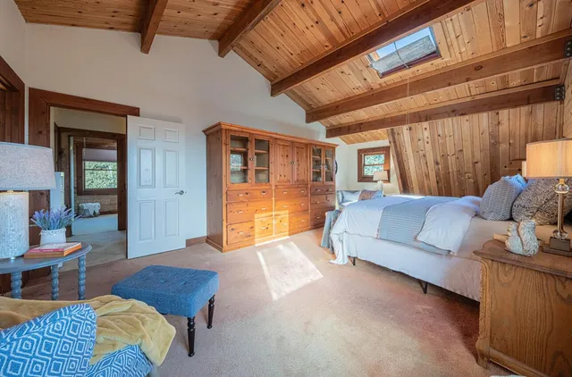 a bed room with a bed and a large mirror