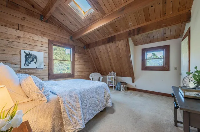 a bedroom with a bed chair and window