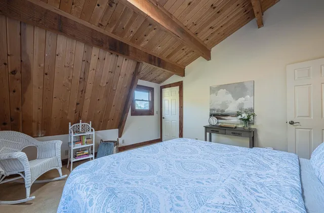 a bedroom with bed and a window