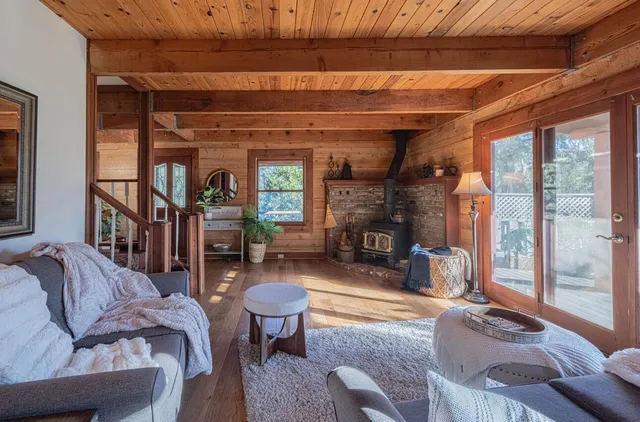 a living room with furniture a fireplace and a table